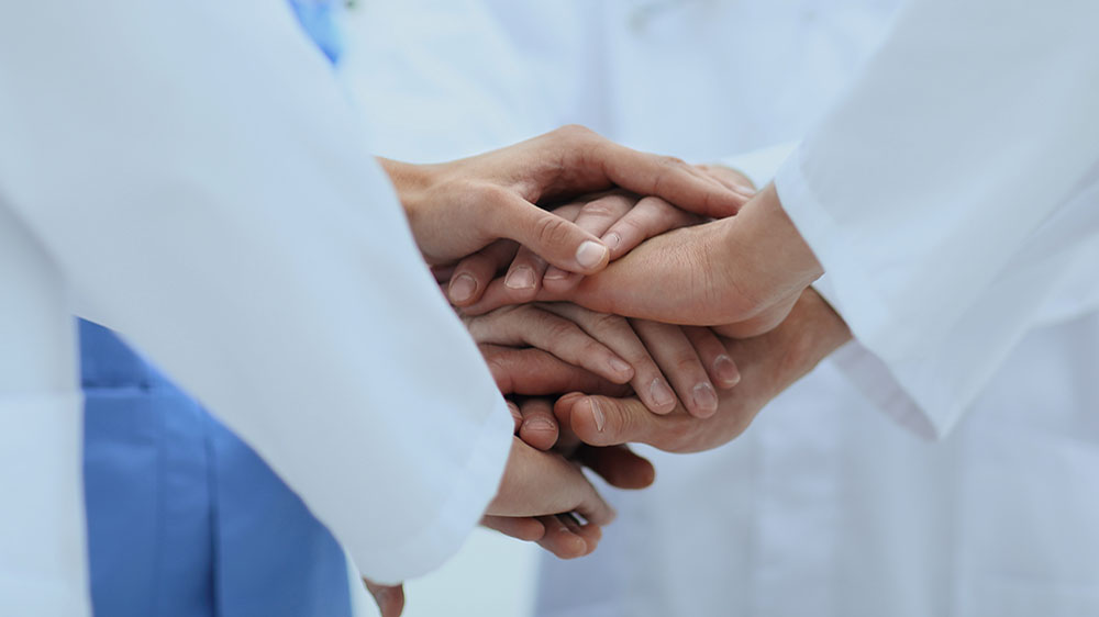 closeup.Small group of doctor team joining hands,