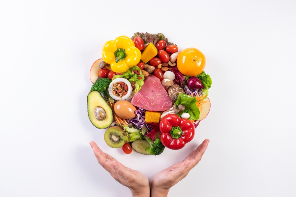 World,Food,Day,,Vegetarian,Day,,Vegan,Day,Concept.,Top,View Fotografi av diverse frukt og grønt som formerer en sirkel. To hender påpeker matens fasong