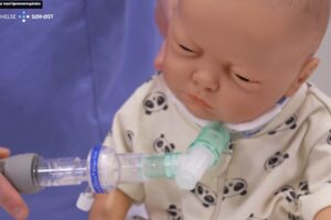 En dukke, hvor respiratorslanger med filter er koblet på tracheostomi