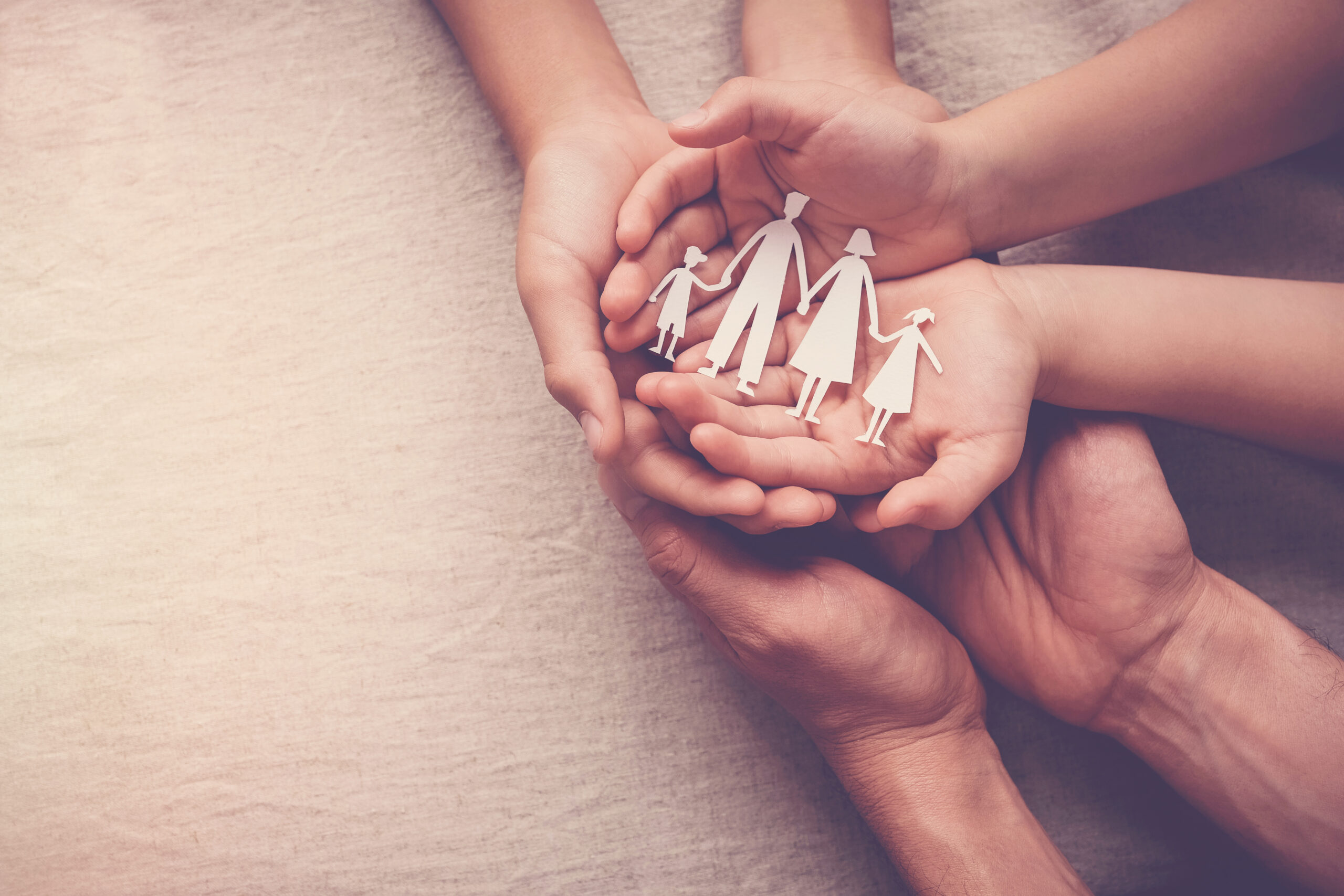 Hands,Holding,Paper,Family,Cutout,,Family,Home,,Foster,Care,,World